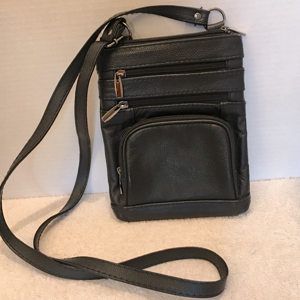 Black leather crossbody with adjustable strap and multiple zipper pockets